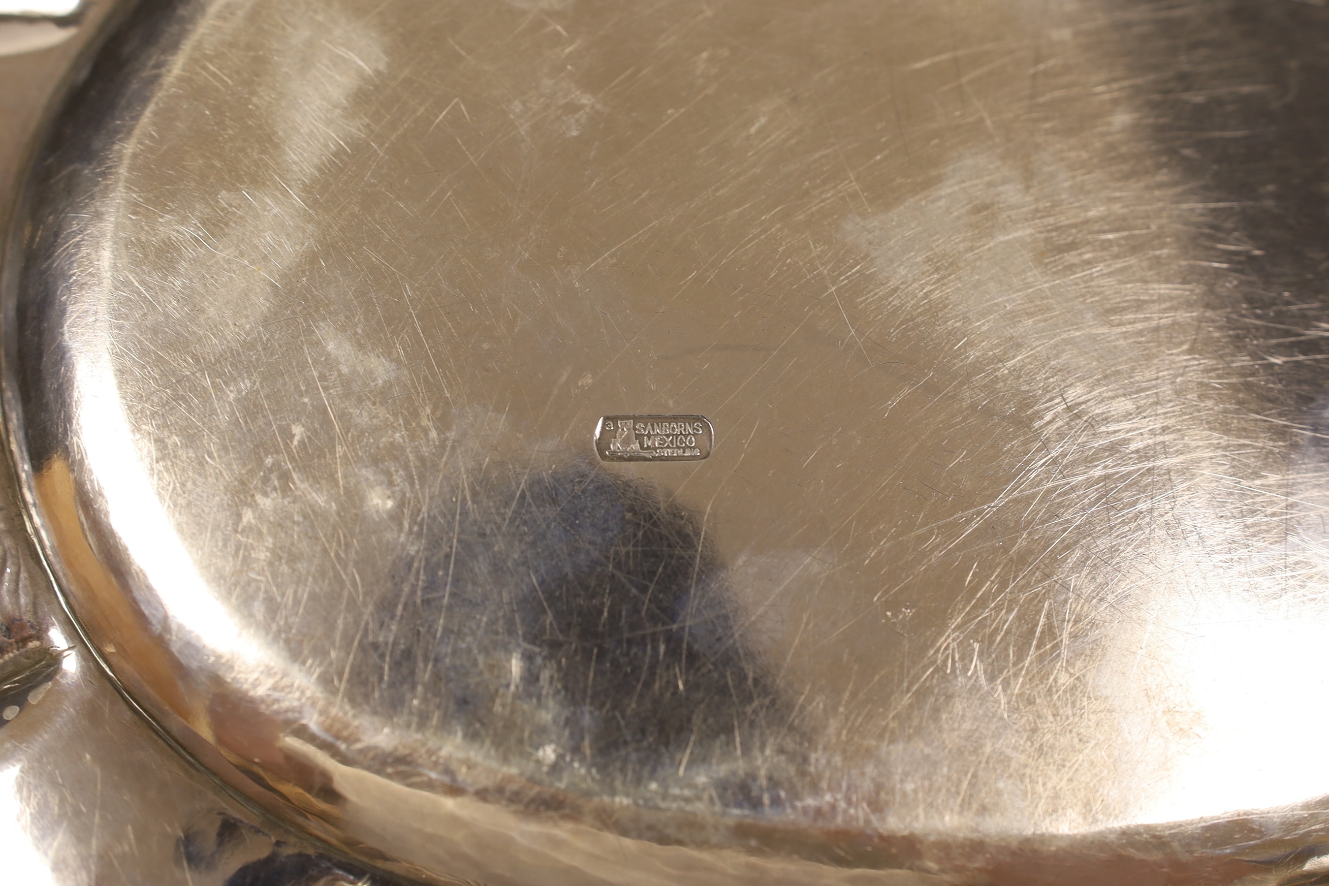 A Mexican sterling oval tray, 40.1cm, a similar bowl on tripod supports, a modern silver sauce boat and oval silver salt, 32.7oz.